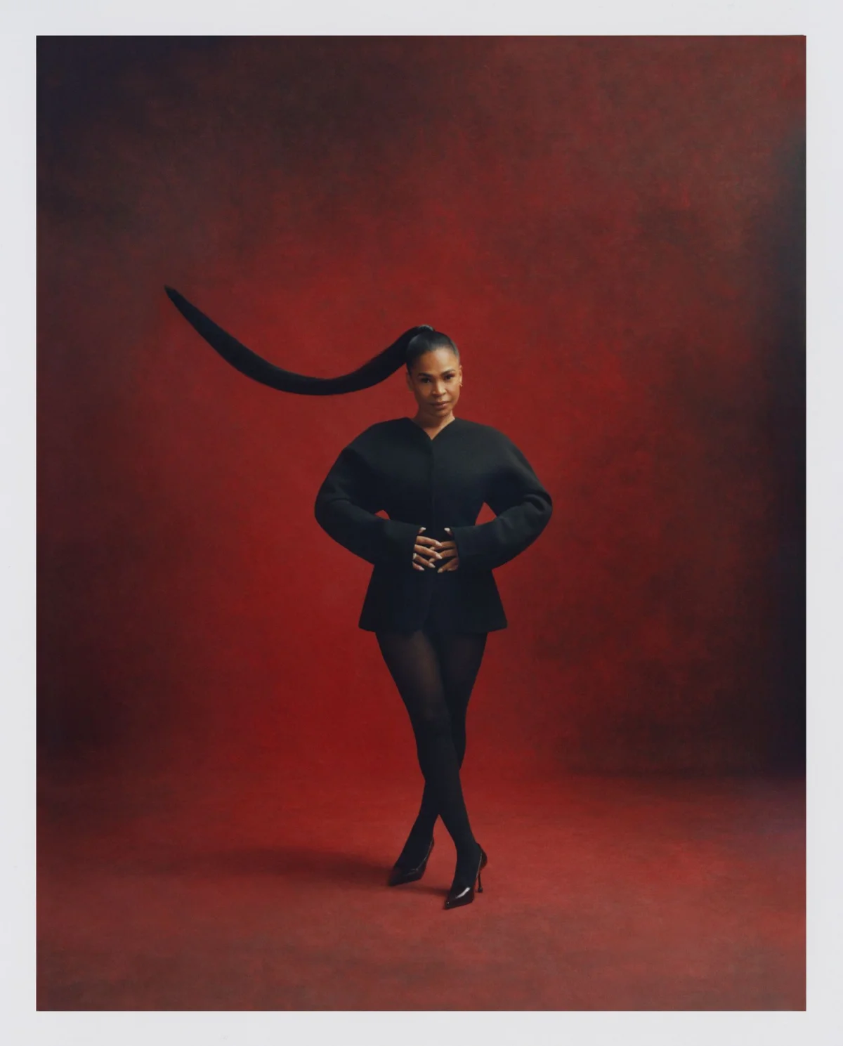 Image may contain Adult Person Face Head Photography Portrait Sword Weapon Clothing Coat Footwear and Shoe
