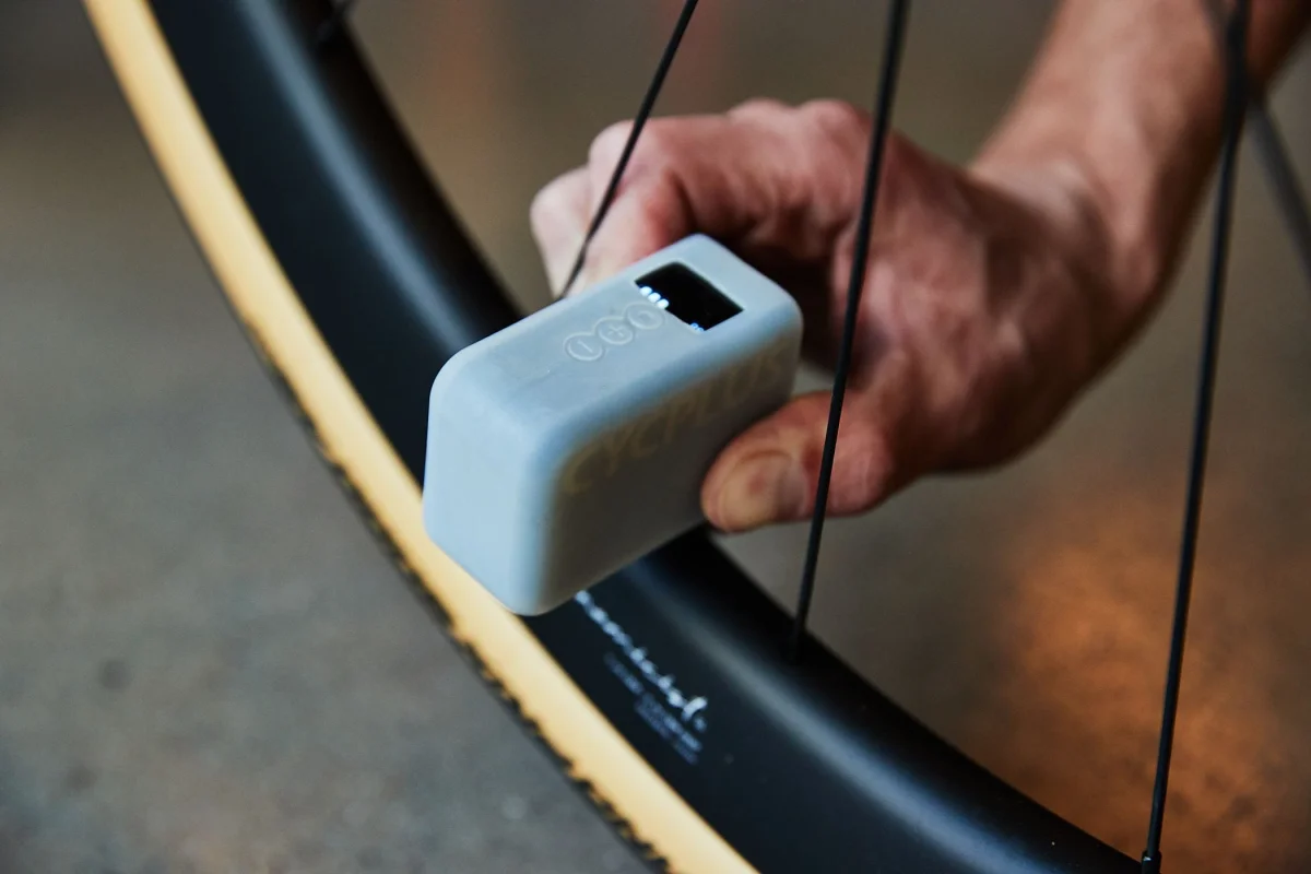 tire pressure monitoring device being held near a bicycle wheel