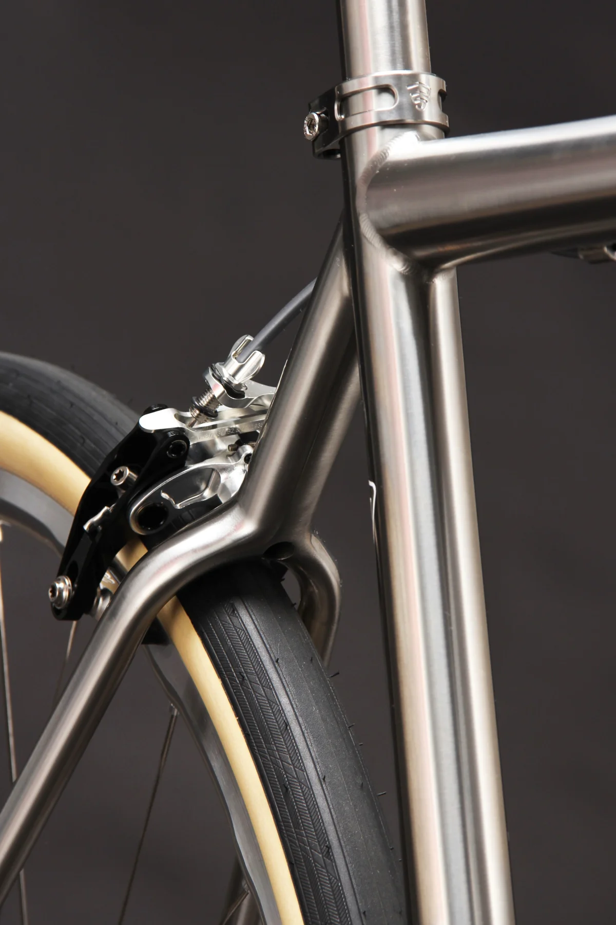 Close-up of a bicycle frame showing the brake assembly and tire detail. Close-up of a bicycle frame showing the brake assembly and tire detail.
